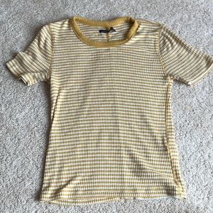 A yellow top with stopped horizontal lines. Shirt can be worn anywhere casually